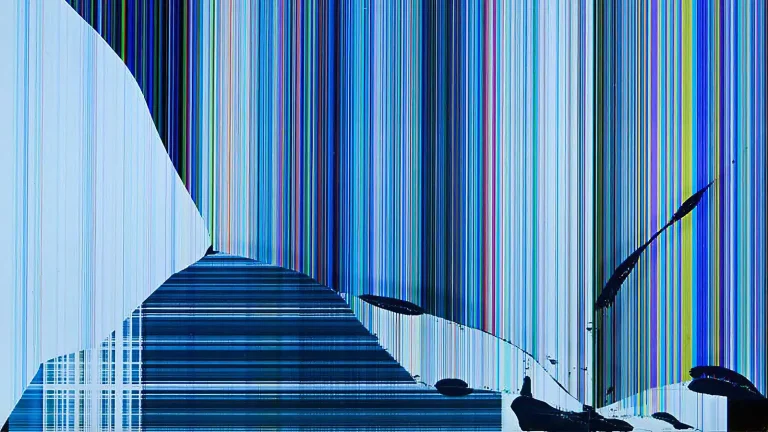 A damaged laptop display with black patches and coloured lines
