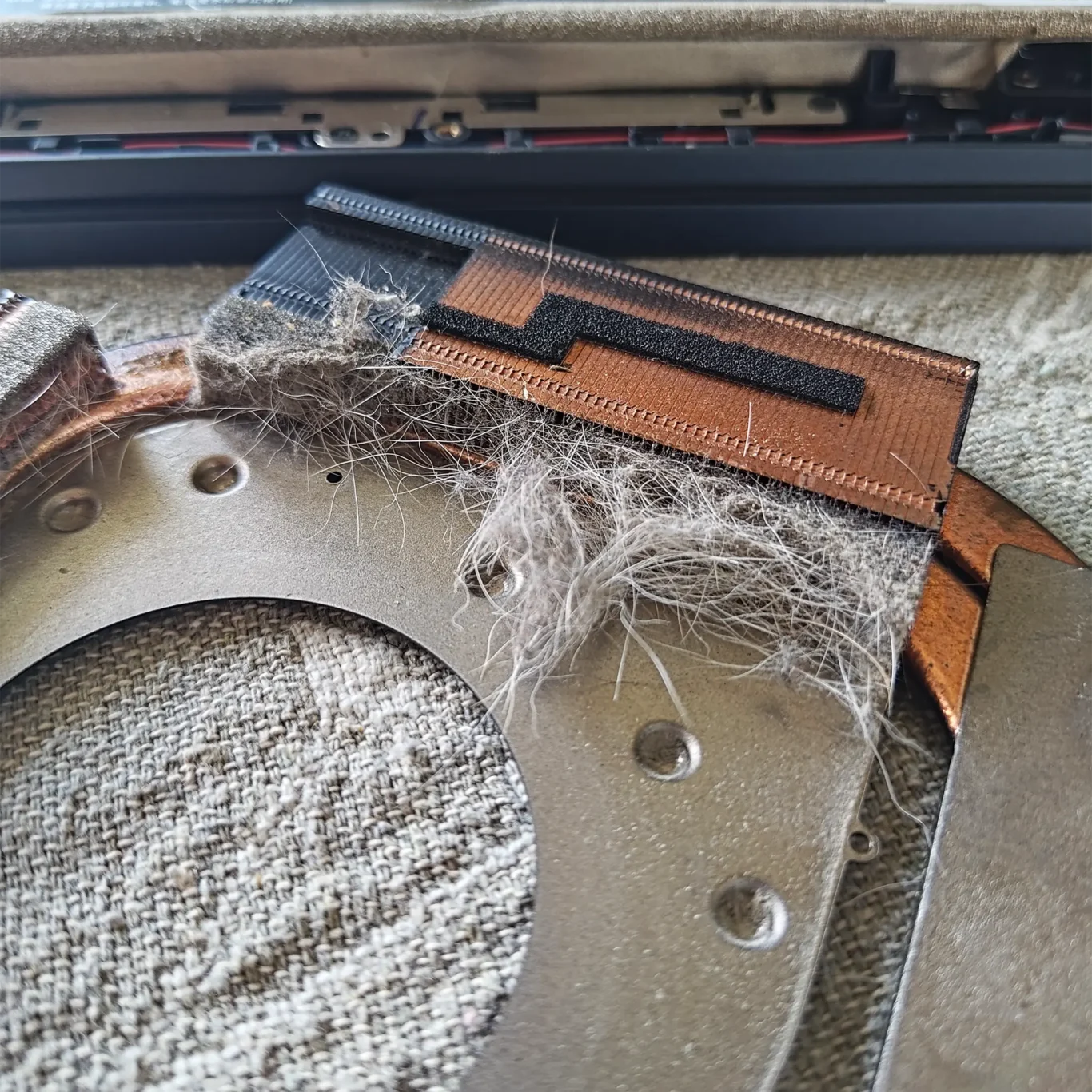 Compacted Household Dust Trapped Inside A Laptop Cooling System Causing Rising Temperatures Over Time