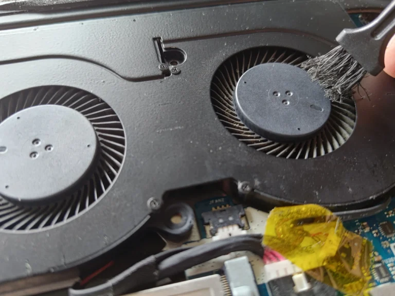 Brush cleaning one of two Acer Nitro AN517-51 blower inlets