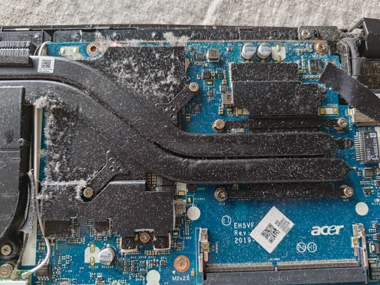 Dust across Acer Nitro 5 AN517-51 heat-pipe covers and motherboard
