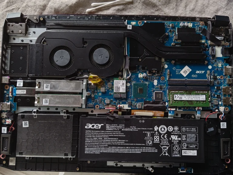 Open Acer Nitro AN517-51 showing battery, twin-fan shroud and motherboard