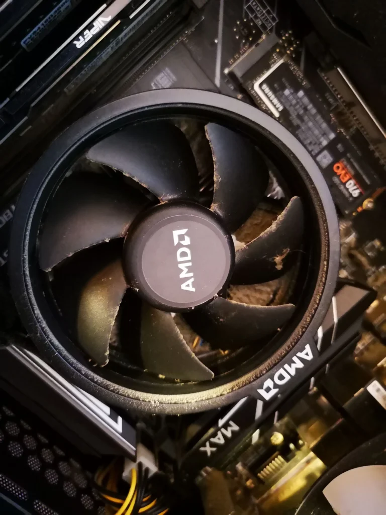 AMD stock CPU fan fitted to a Ryzen desktop before cooler inspection