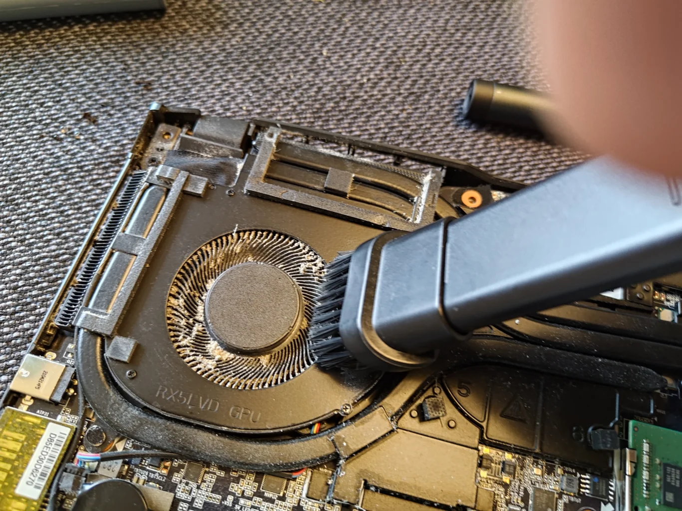 Cleaning near AORUS laptop blower and outlet fins