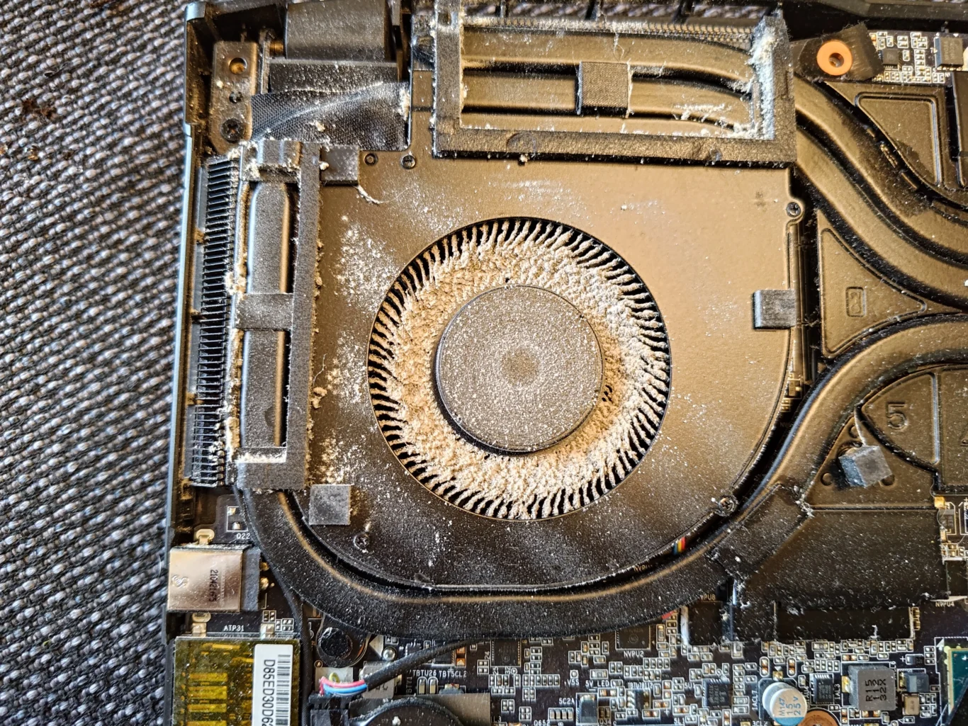 Dust on AORUS gaming laptop blower wheel and housing
