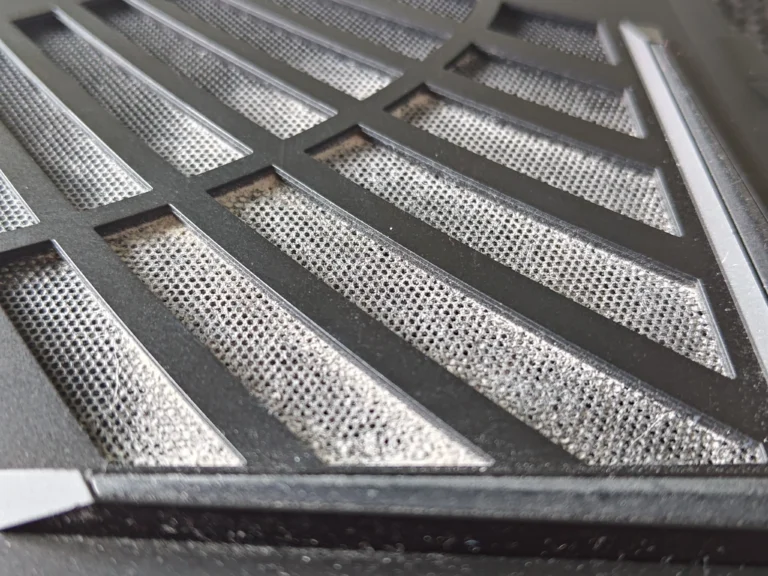 Close-up of dust caught in AORUS laptop intake grille