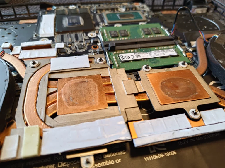 Lifted AORUS laptop copper cooler showing two thermal contact plates