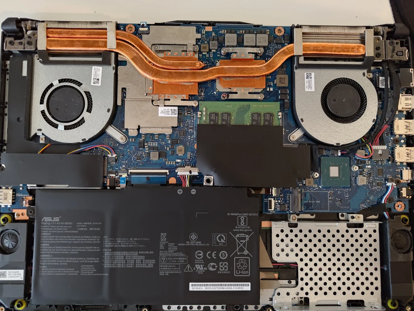 ASUS FX506LH interior with two blower fans and shared copper cooling pipes