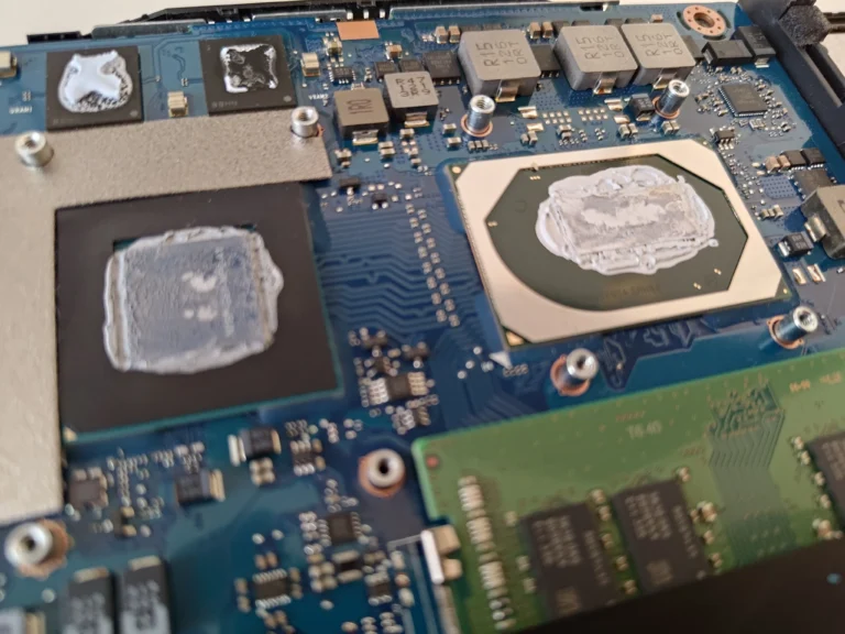 Two ASUS FX506LH chip surfaces with thermal compound after cooler removal