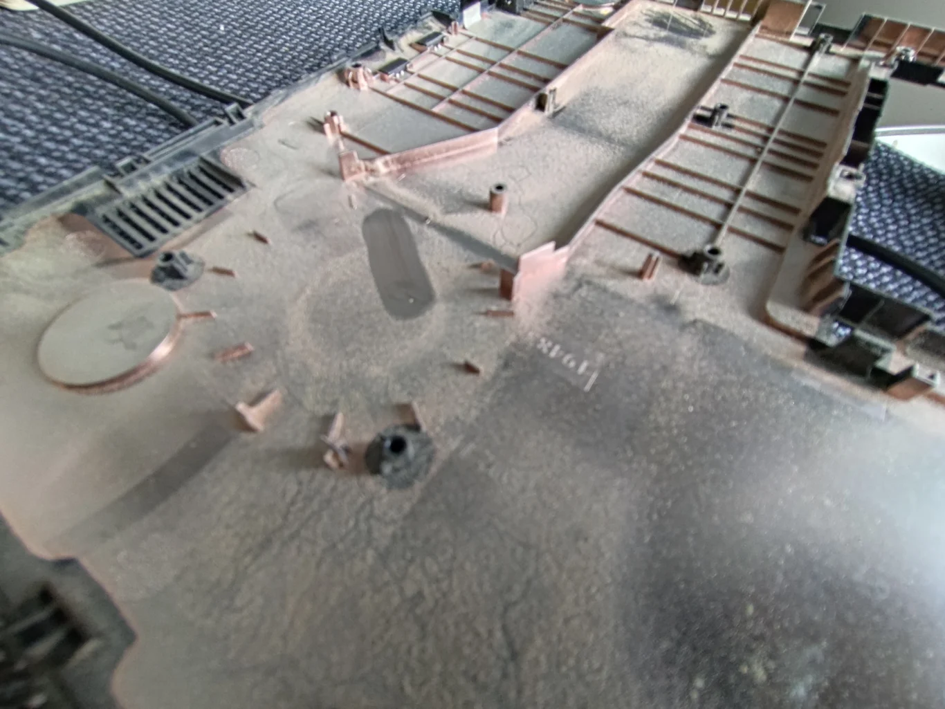 Dust film across underside of lifted ASUS R517S keyboard deck