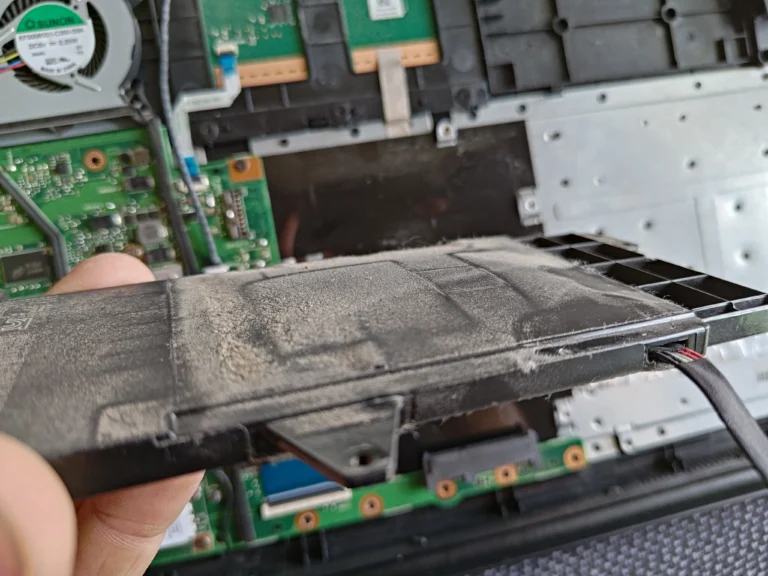 Dust on plastic edge of lifted ASUS R517S keyboard deck