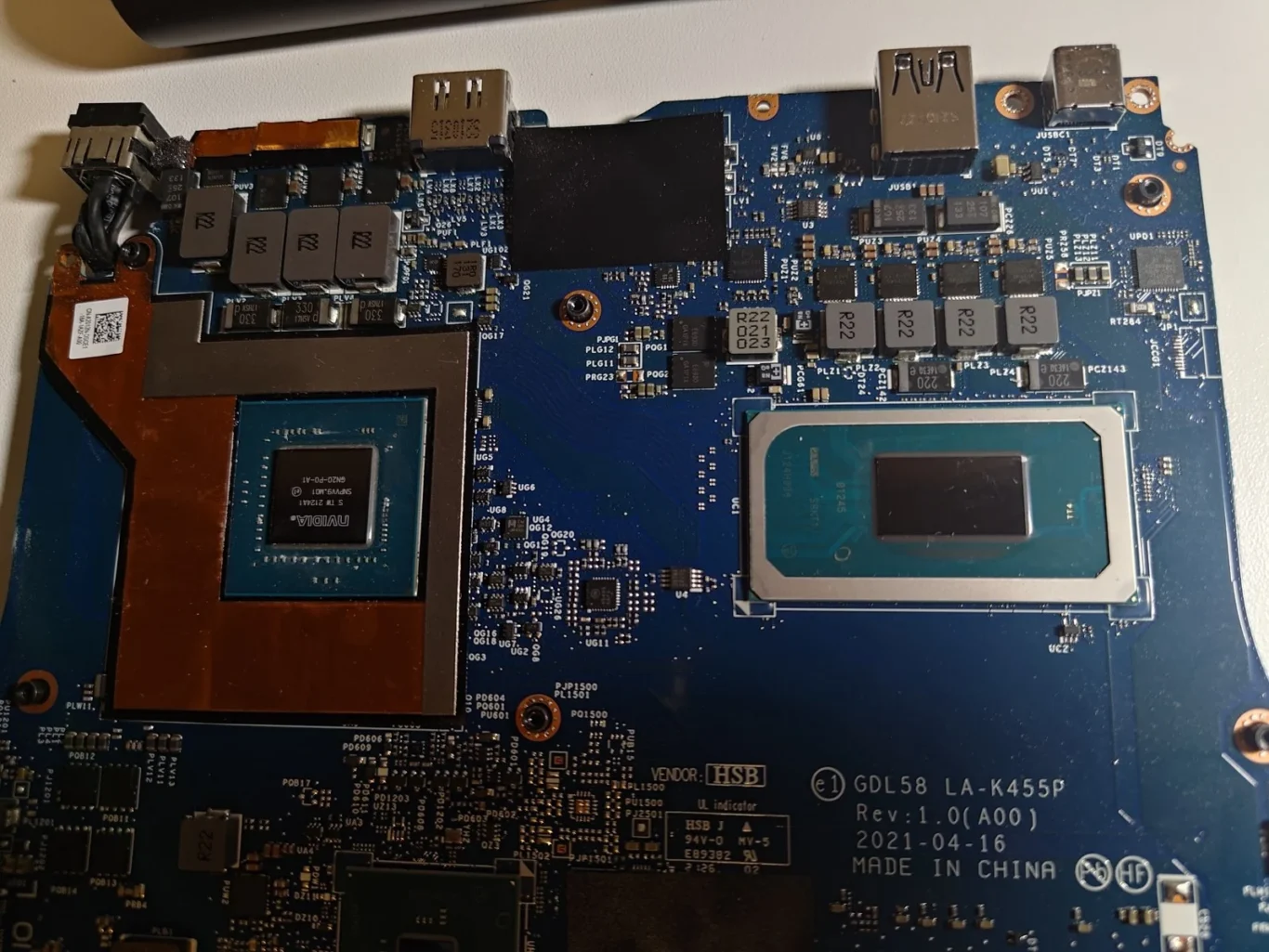 Exposed NVIDIA graphics chip and Intel processor on a Dell G15 motherboard after old paste has been removed