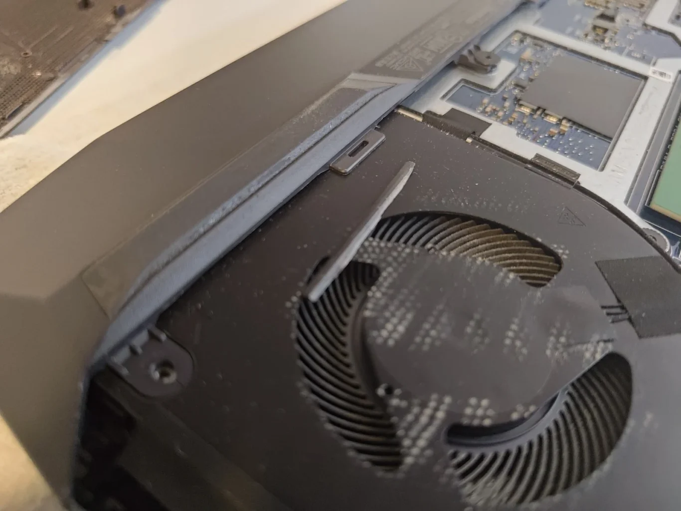 Close-up of dust collected on curved fan blades inside a Dell G15 5511 laptop
