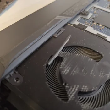 Close-up of dust collected on curved fan blades inside a Dell G15 5511 laptop