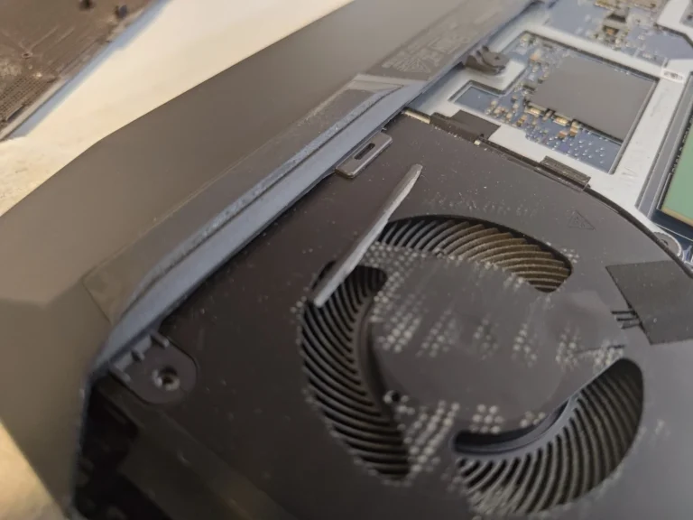 Close-up of dust collected on curved fan blades inside a Dell G15 5511 laptop