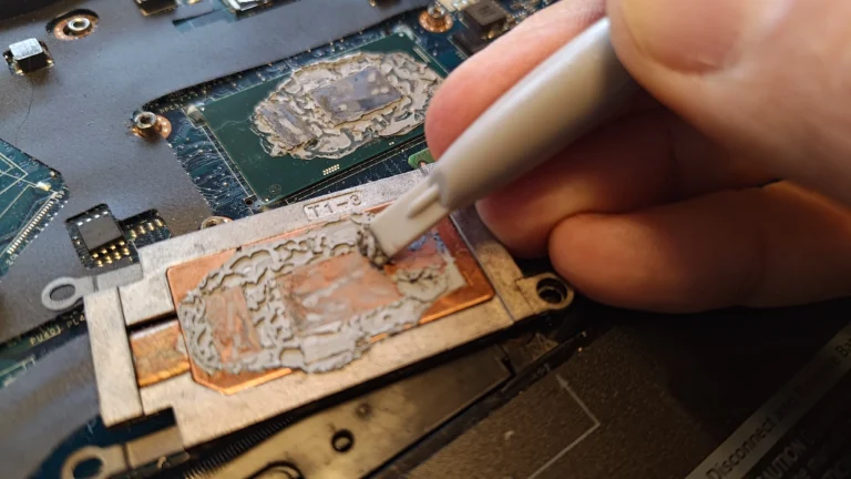 Old thermal compound being cleaned from Dell Latitude copper cooler plate
