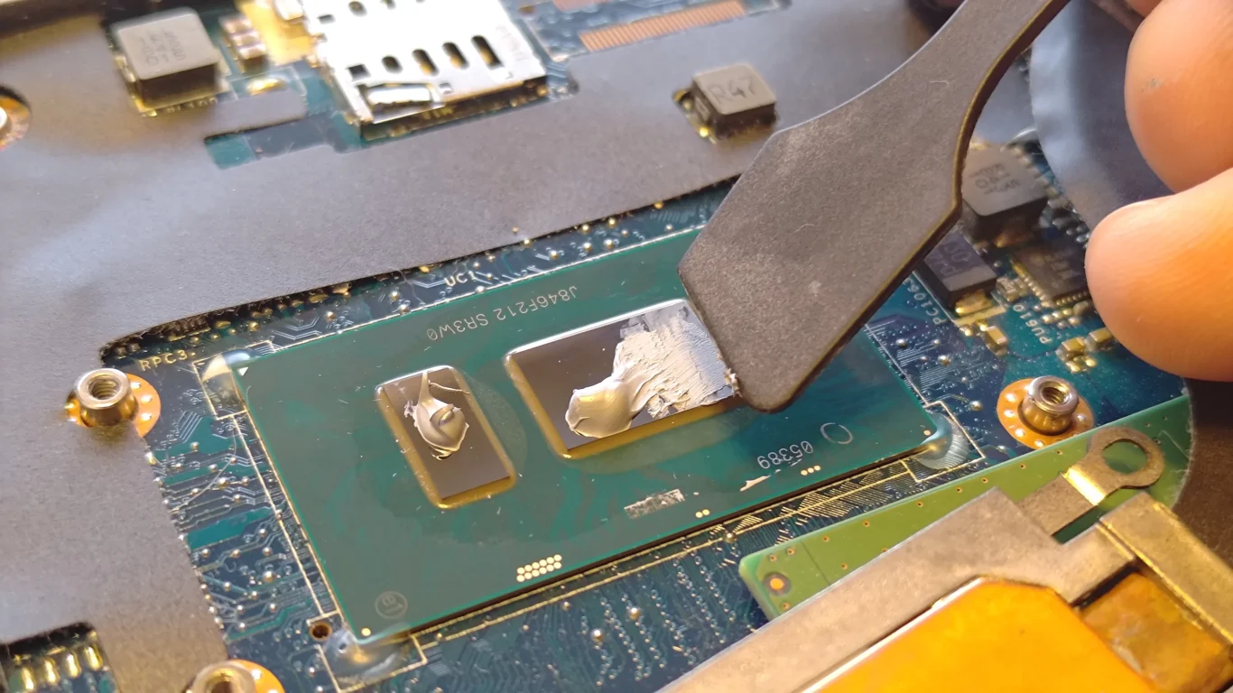 Fresh thermal compound spread over two Dell Latitude contact areas