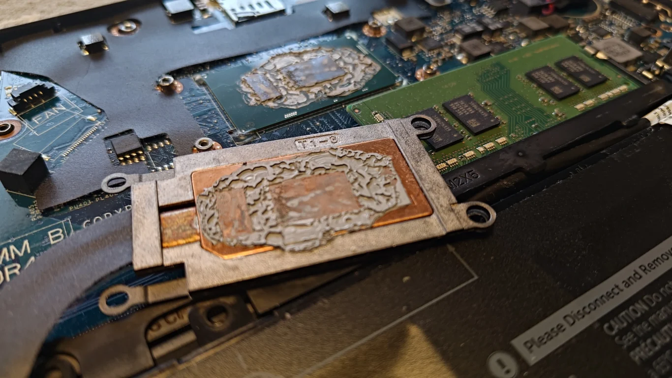 Old thermal compound on two Dell Latitude processor-package contact areas and copper plate