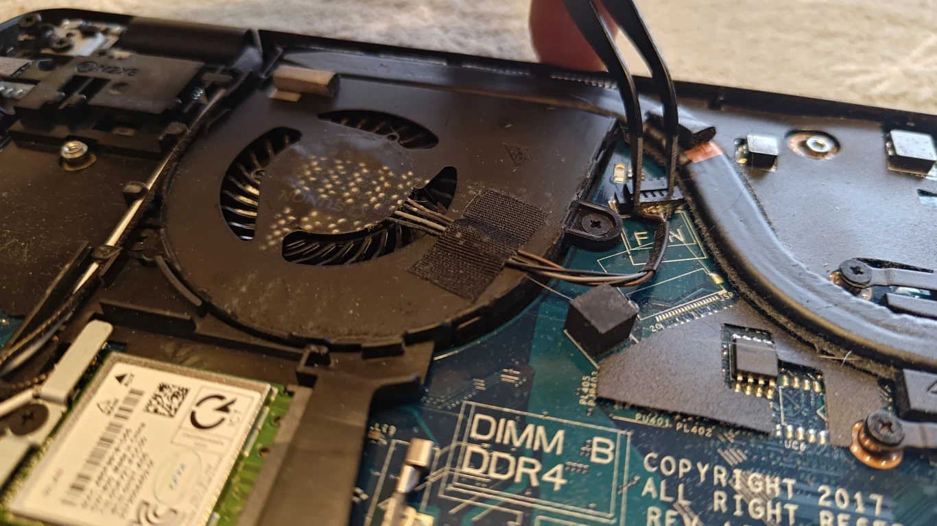 Single Dell Latitude blower fan with visible dust inside open laptop
