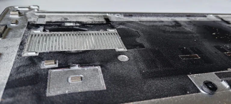 Dust film over the inside of a Dell XPS bottom-cover intake grille