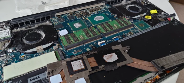 Dell XPS processor and graphics contact surfaces exposed after cooler removal