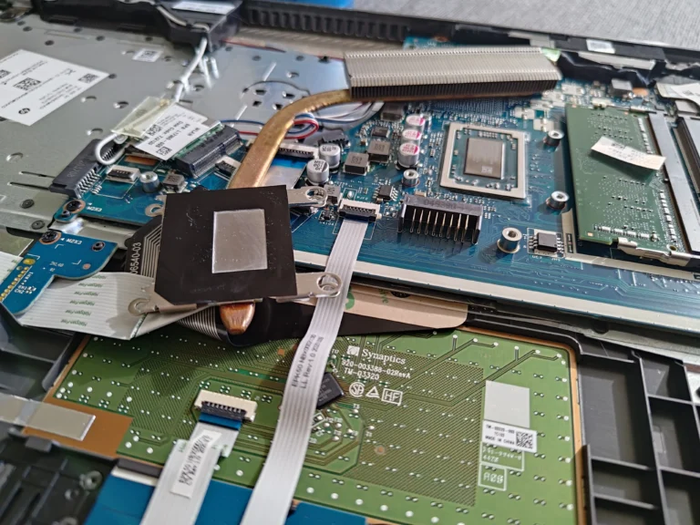 HP 255 G7 board with cooling assembly lifted for cleaning and repasting