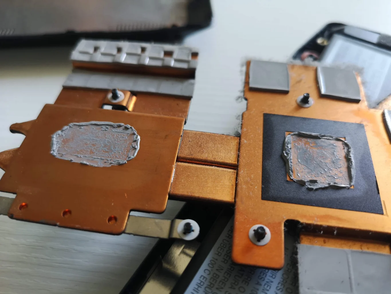 Underside of IdeaPad Gaming copper cooler showing old compound and surrounding pads