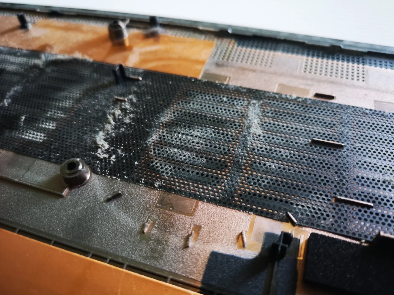 Dust film on the inner lower-cover mesh of a Lenovo IdeaPad Gaming laptop