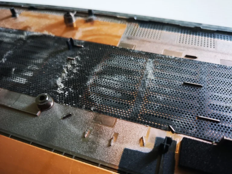 Dust film on the inner lower-cover mesh of a Lenovo IdeaPad Gaming laptop