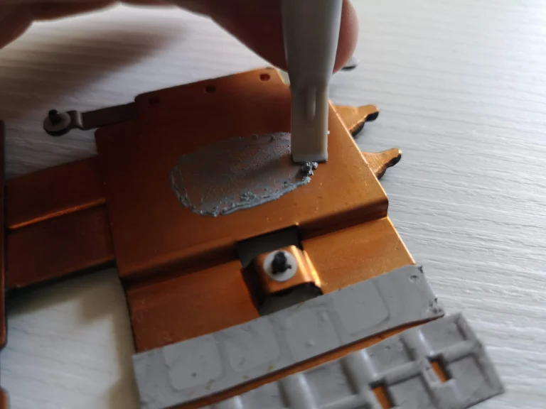Fresh thermal compound being dispensed onto a Lenovo IdeaPad Gaming copper contact