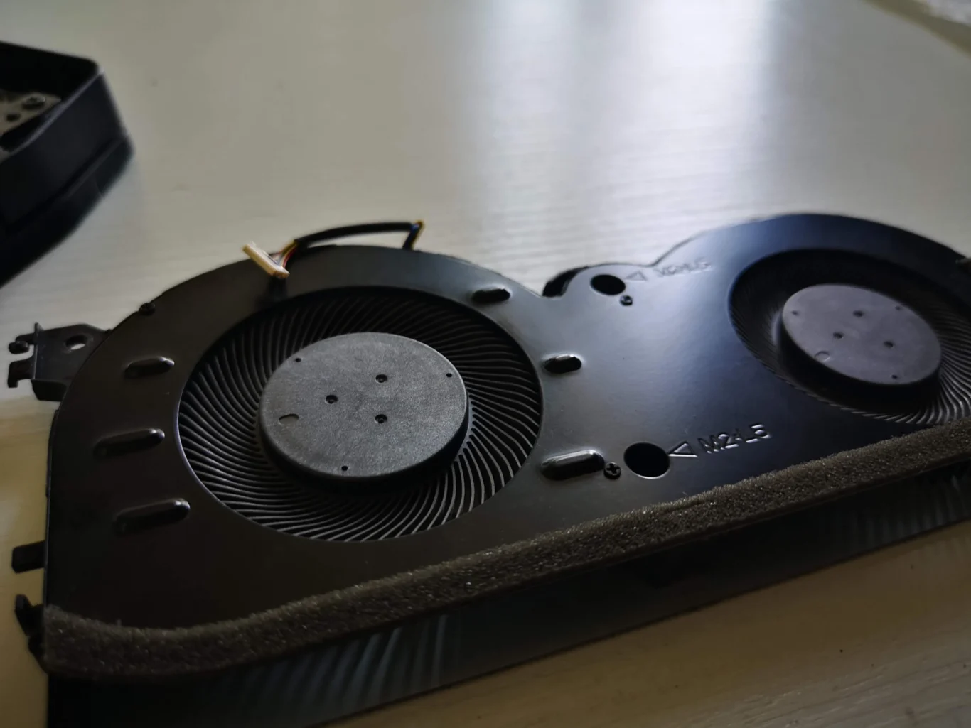 Removed Lenovo IdeaPad Gaming blower module showing two differently sized wheels