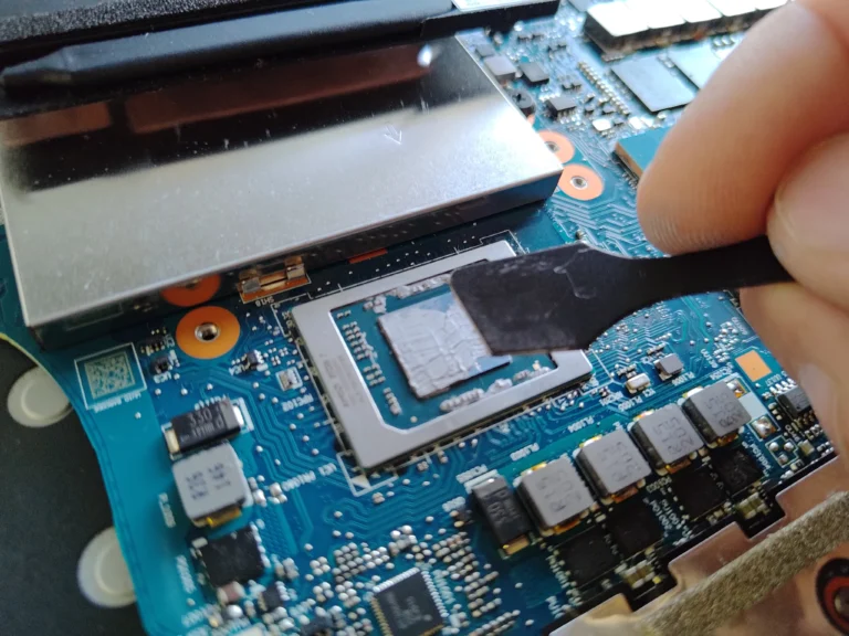 Tool carefully removing old thermal compound from Lenovo Legion processor