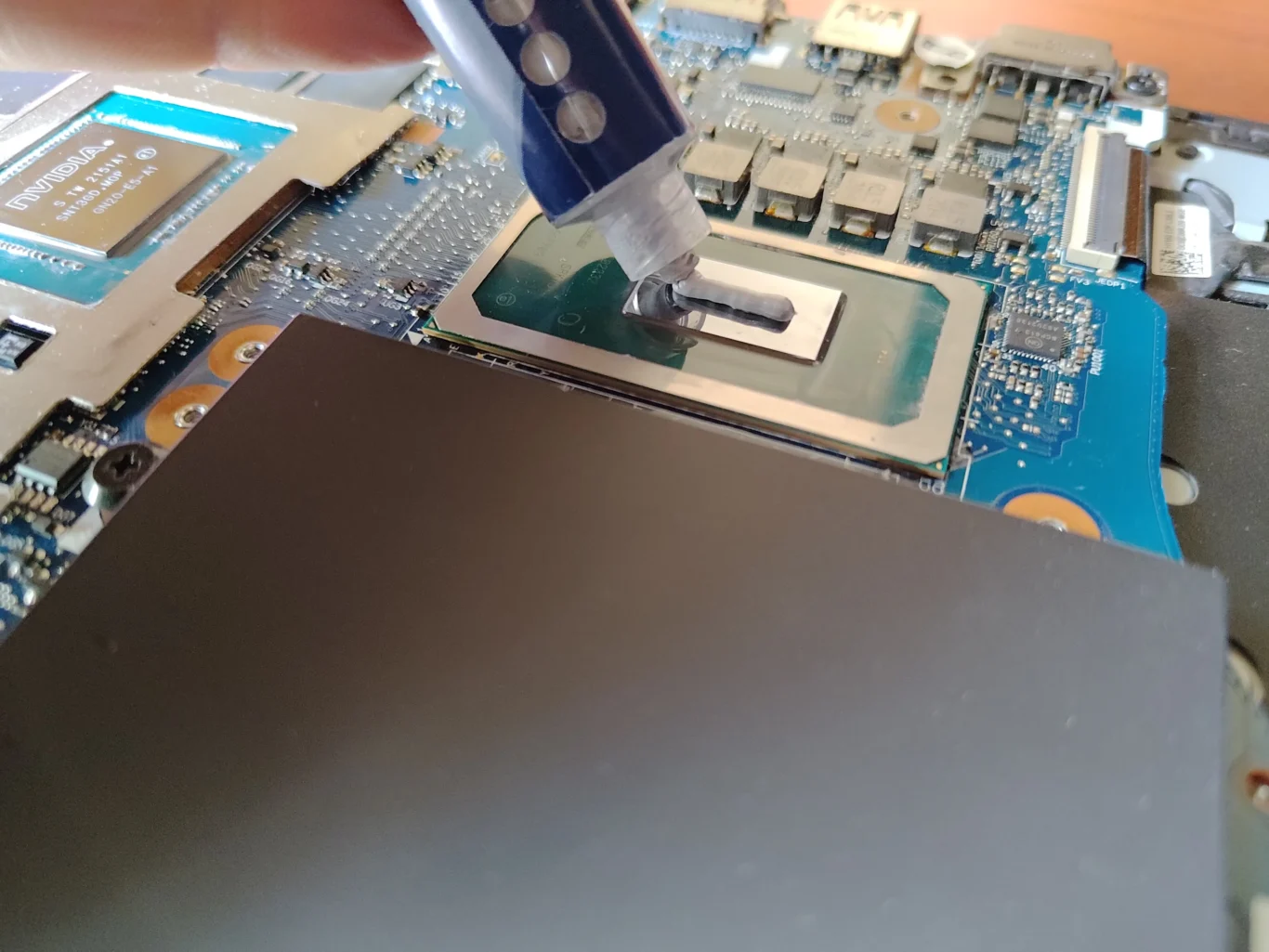 Fresh thermal compound dispensed onto Lenovo Legion processor