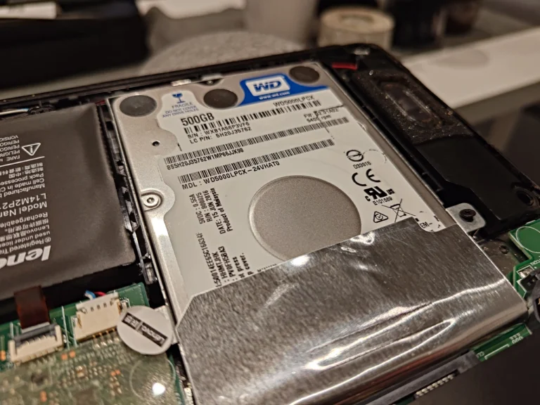 Original Lenovo laptop hard drive in its carrier with protective cover