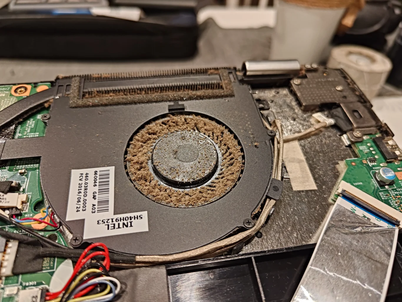 Thick brown dust ring around cooling fan blades inside Lenovo laptop