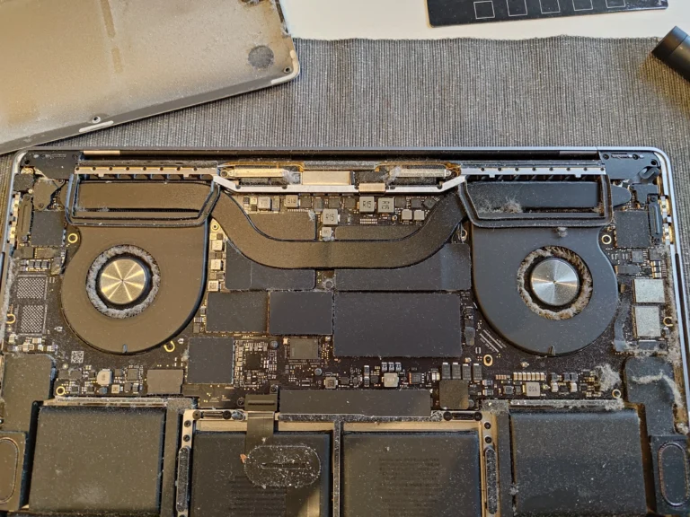 MacBook Pro 16-inch A2141 opened to show both cooling fans before cleaning