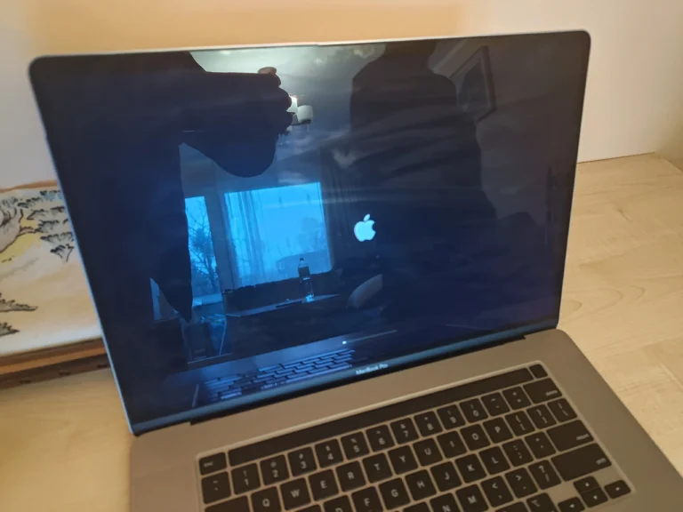 Silver 16-inch MacBook Pro on the workbench before internal cleaning