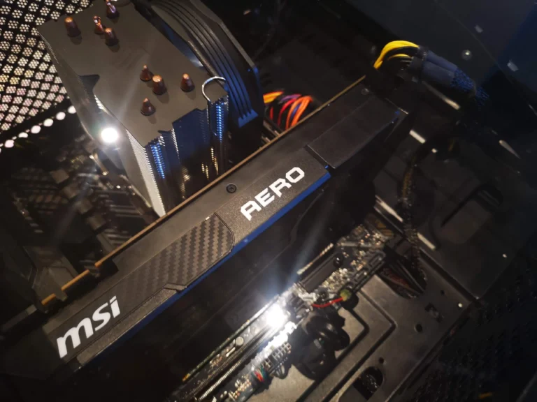 MSI Aero graphics card installed beside a Ryzen tower CPU cooler