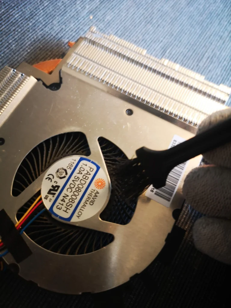 MSI GF63 cooling fan being accessed beside its fin stack