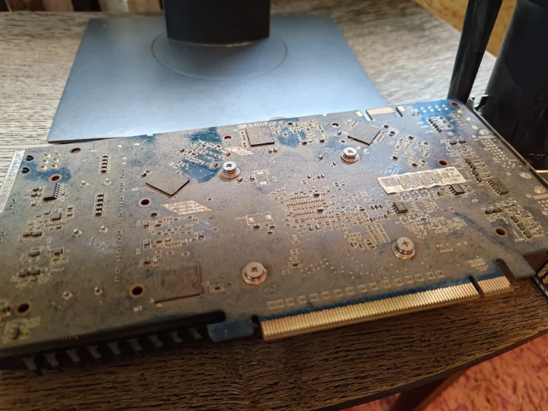 Dust across removed graphics card board in older desktop PC