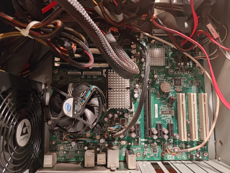Older desktop interior showing CPU fan, graphics-card slot and cable routing
