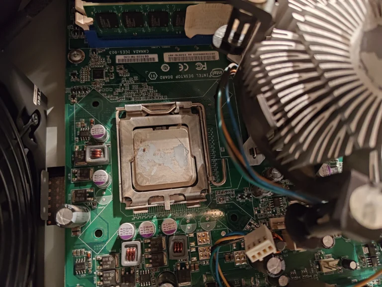 Intel processor exposed with radial cooler lifted beside it