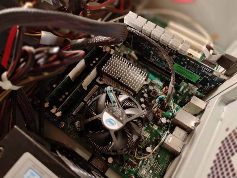 Older desktop motherboard with Intel radial CPU fan and separate passive heatsink