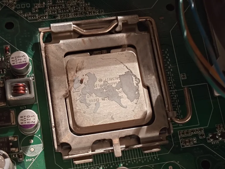 Old thermal compound residue on Intel desktop processor in its socket