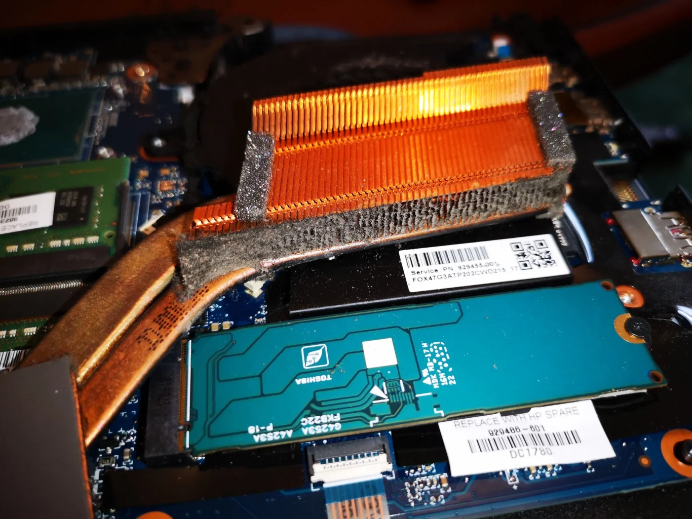 Felt-like dust line across copper heatsink fin outlet of Razer gaming laptop