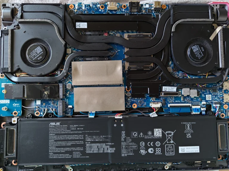 Open ROG Strix G513RW with two fans and shared heat-pipe cooler