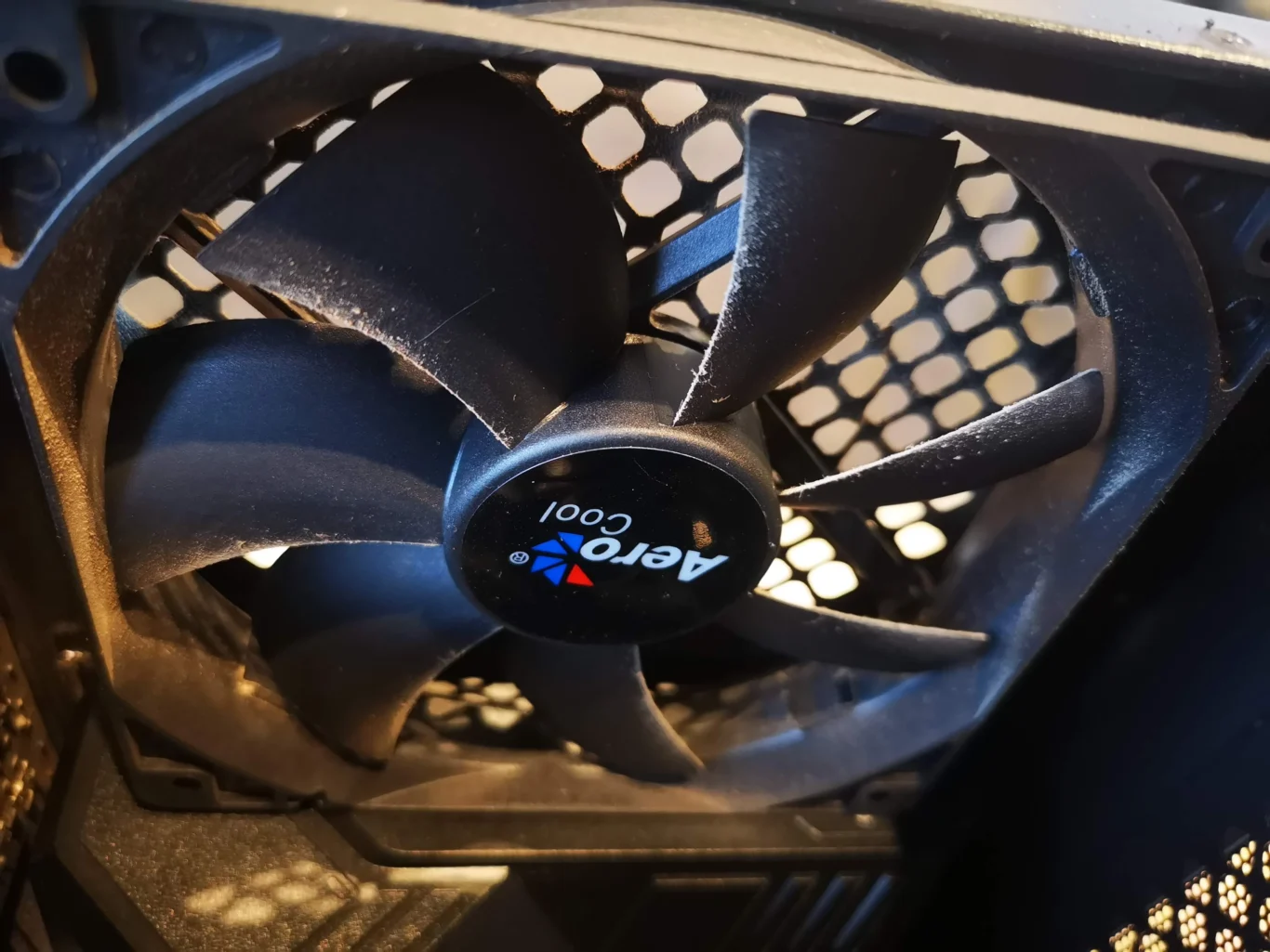 Rear exhaust case fan behind honeycomb grille in Ryzen desktop