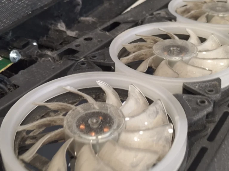 Two white desktop case fans with dust on blades and frames
