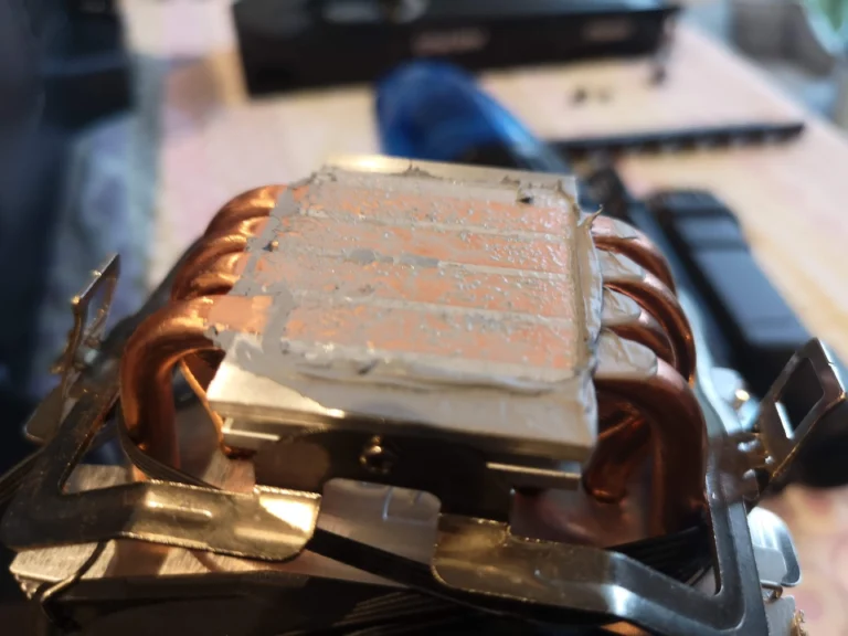 Removed Ryzen tower CPU cooler base with old thermal paste on copper contact plate