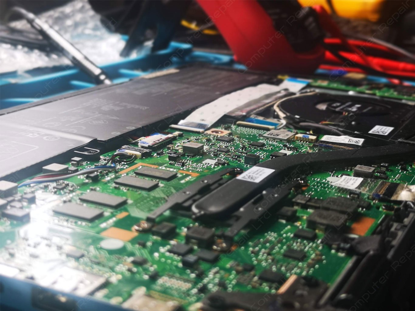 Laptop motherboard on a repair bench during diagnosis