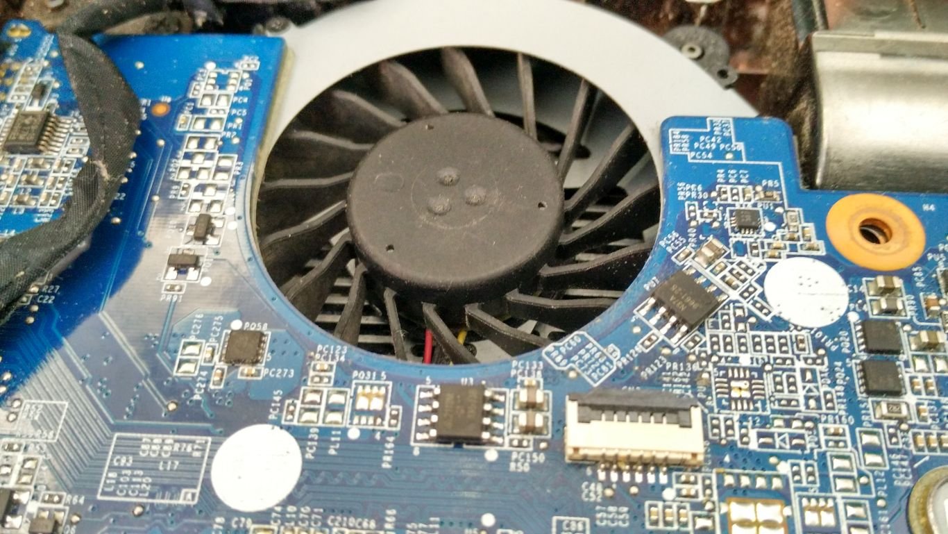 Dust-covered laptop cooling fan before cleaning
